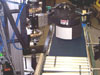 VDR-1 axis and preferred flat belt rough surface conveyor for labelling of lightweight shipping cases.